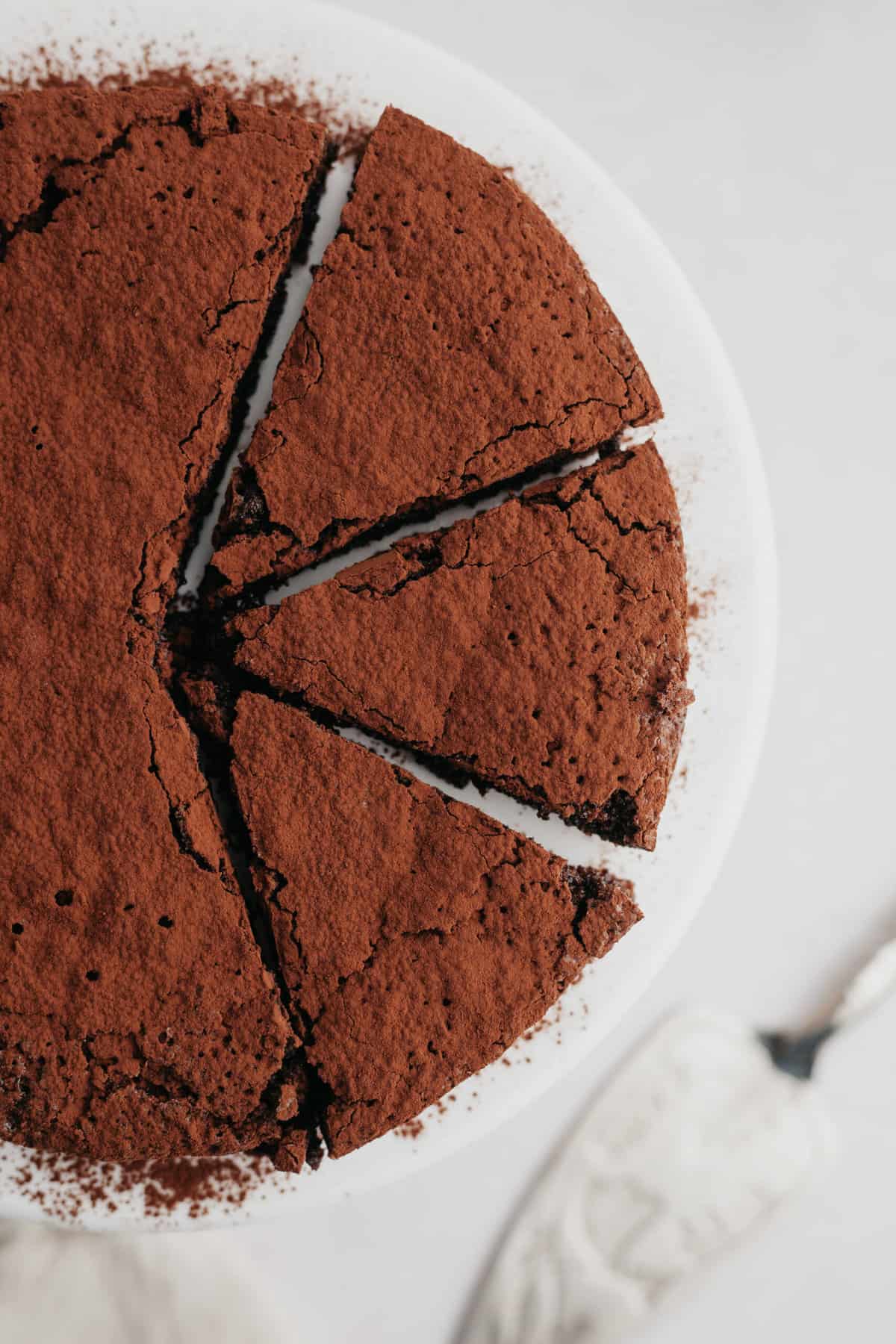 overhead view of slices of chocolate cake dusted with cocoa powder