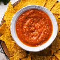 canning salsa in a bowl surrounded by tortilla chips