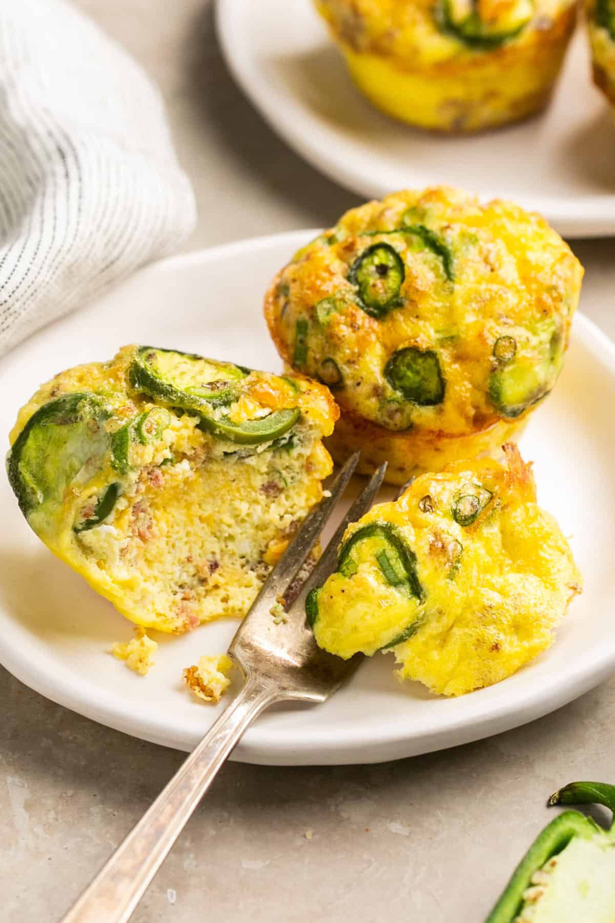 breakfast muffins cut into by a fork on a plate
