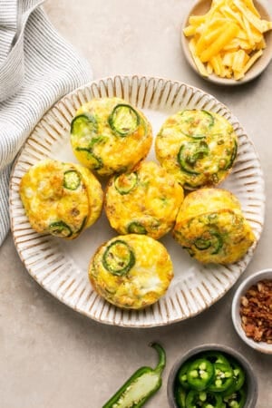 platter of breakfast muffins with jalapenos and bacon on a plate