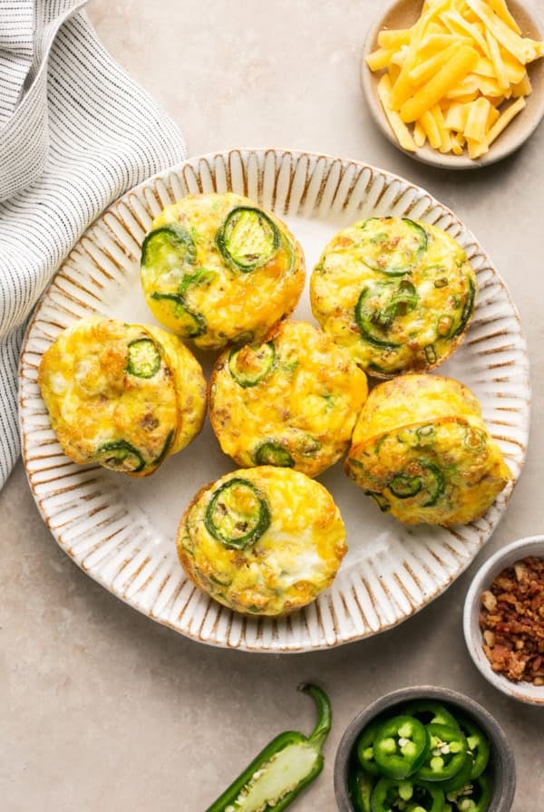 platter of breakfast muffins with jalapenos and bacon on a plate