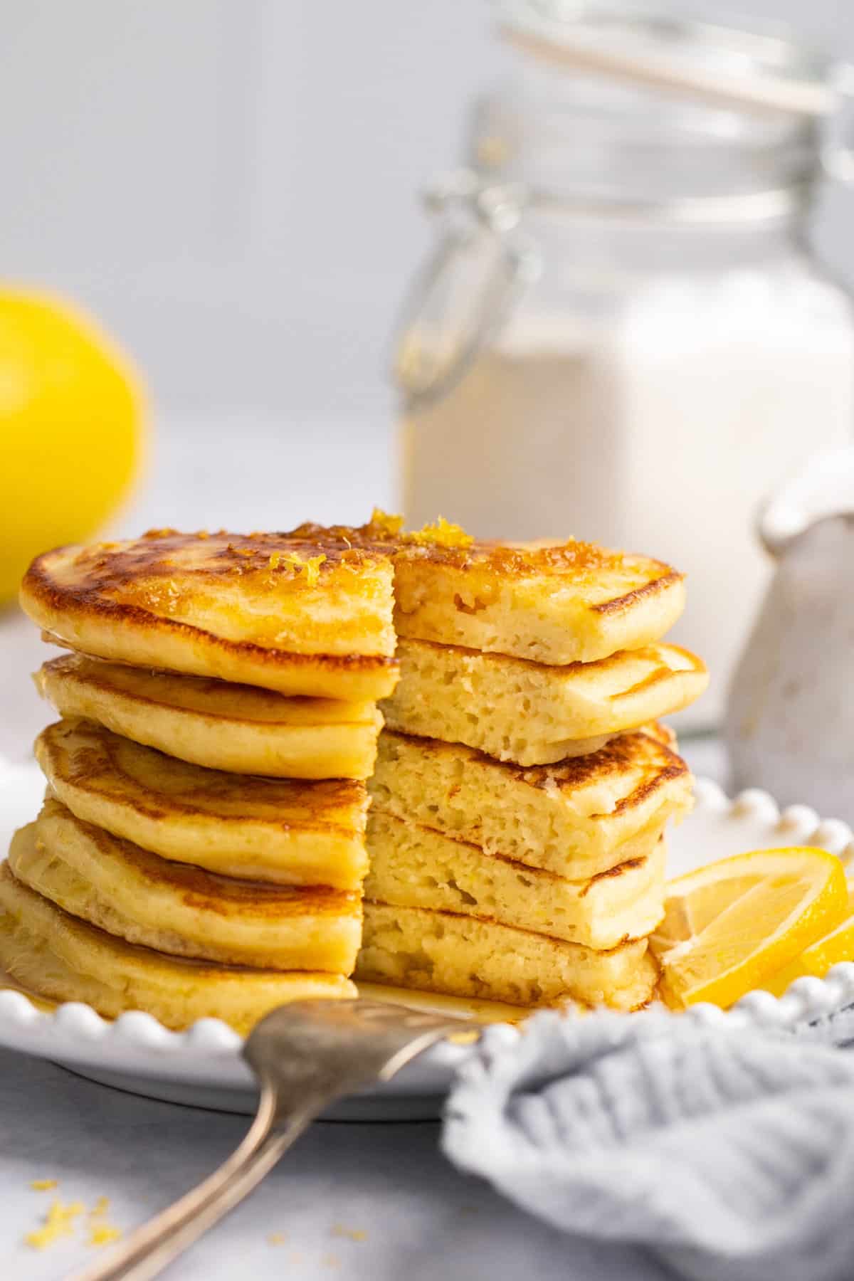 stack of pancakes on plate with section cut out of pancakes