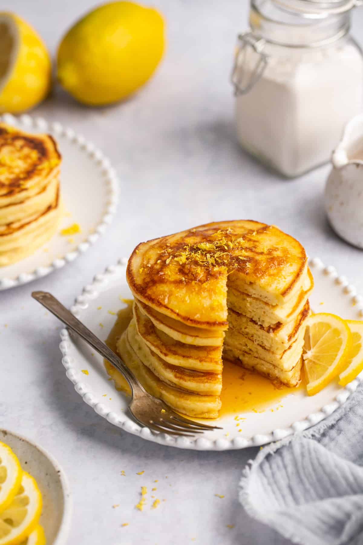 lemon pancakes on plate with fork and syrup