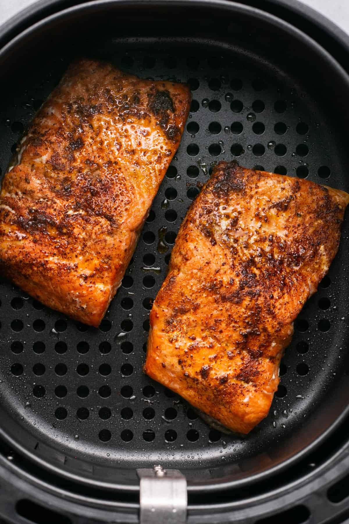 cooked salmon fillets in air fryer basket