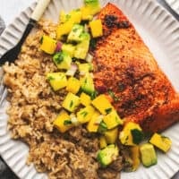 plate of rice with mango salsa and salmon
