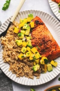 plate of rice with mango salsa and salmon