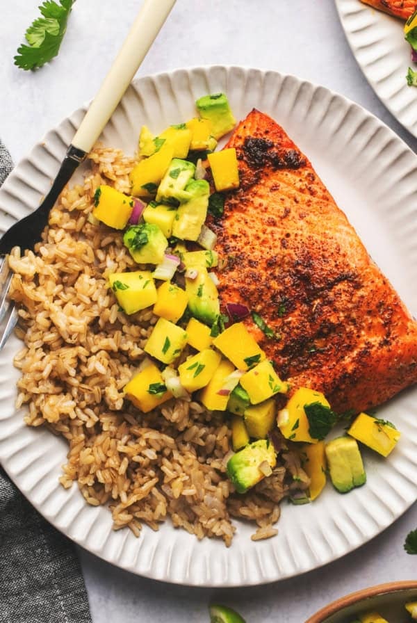 plate of rice with mango salsa and salmon