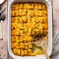 wooden spoon scooping tater tot casserole