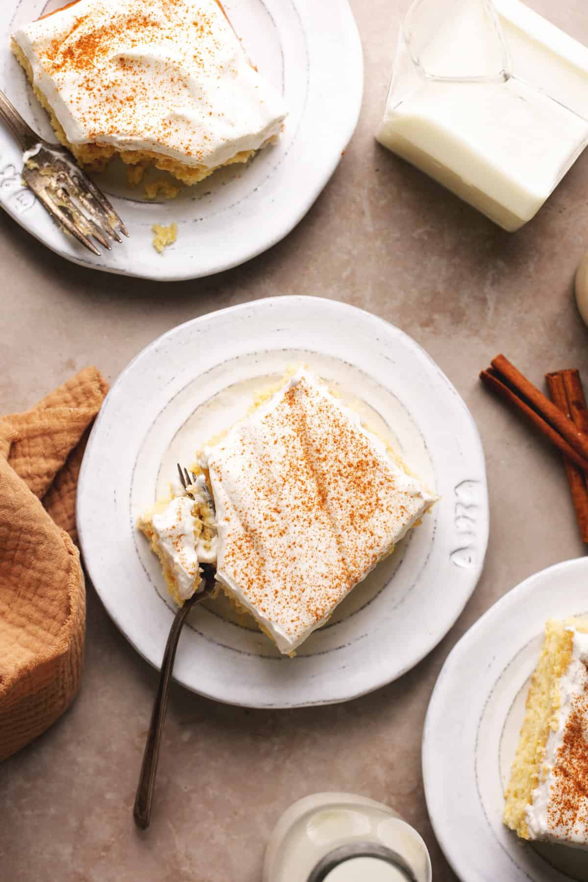 overhead view of pieces of tres leches cake on plates