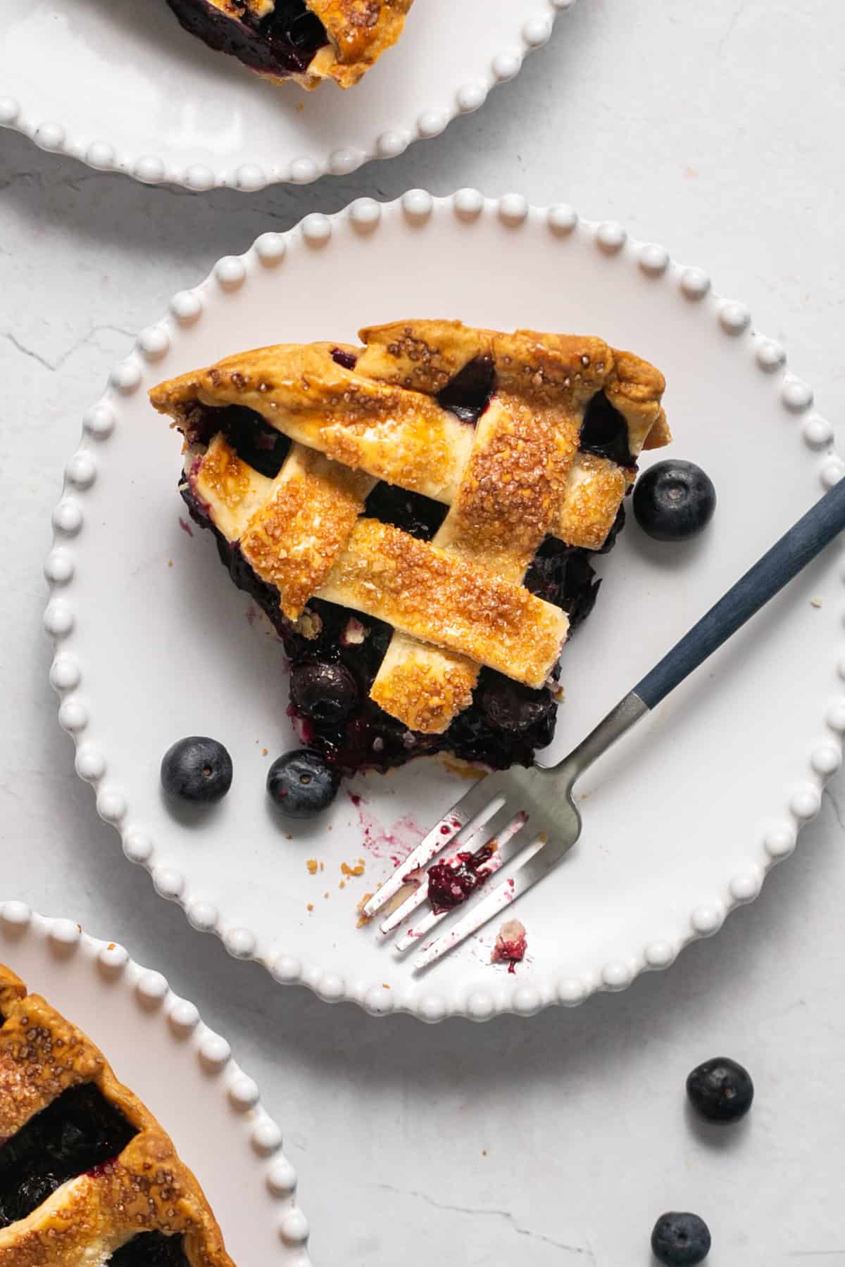 single slice of pie with bite out and fork beside on plate