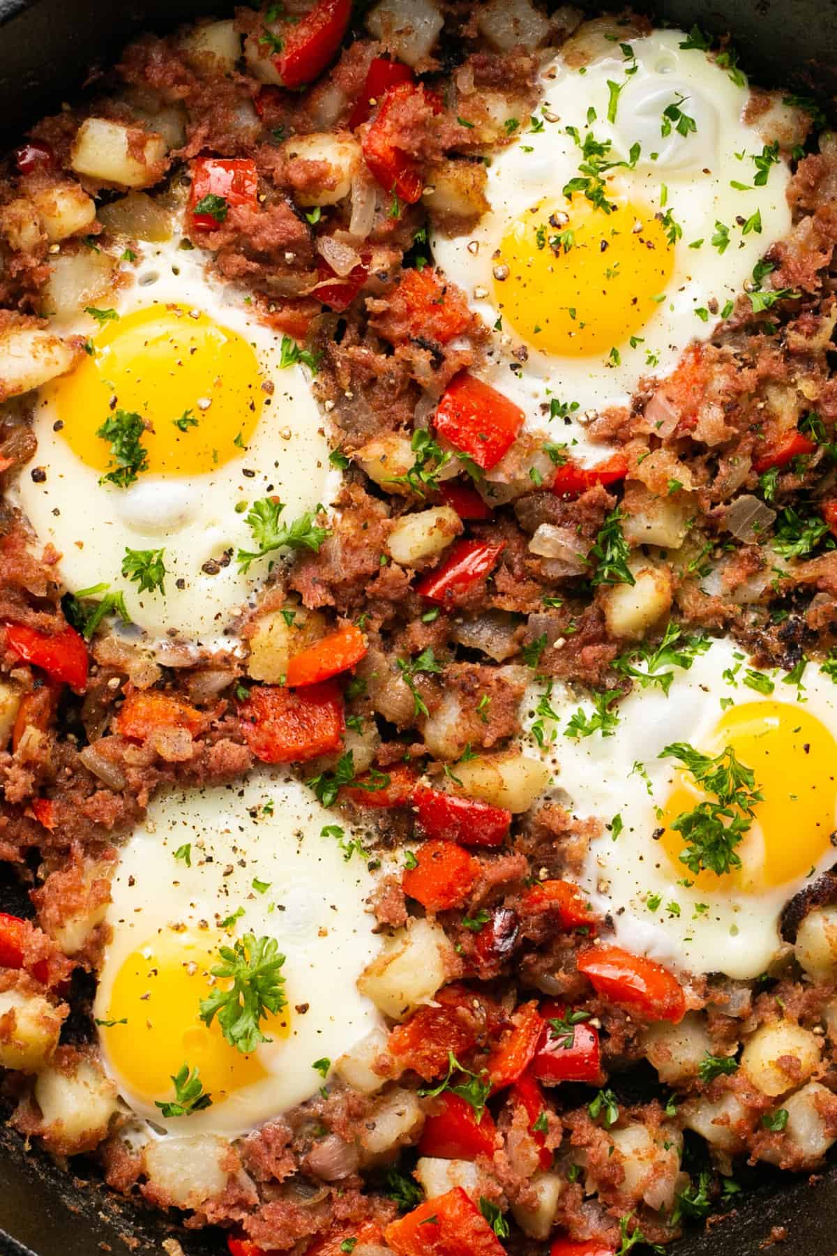 up close fried eggs with corned beef and veggies