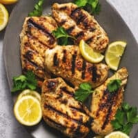 grilled greek marinated chicken on a platter