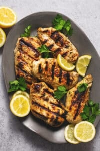 grilled greek marinated chicken on a platter