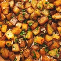 up close breakfast potatoes with serving spoon