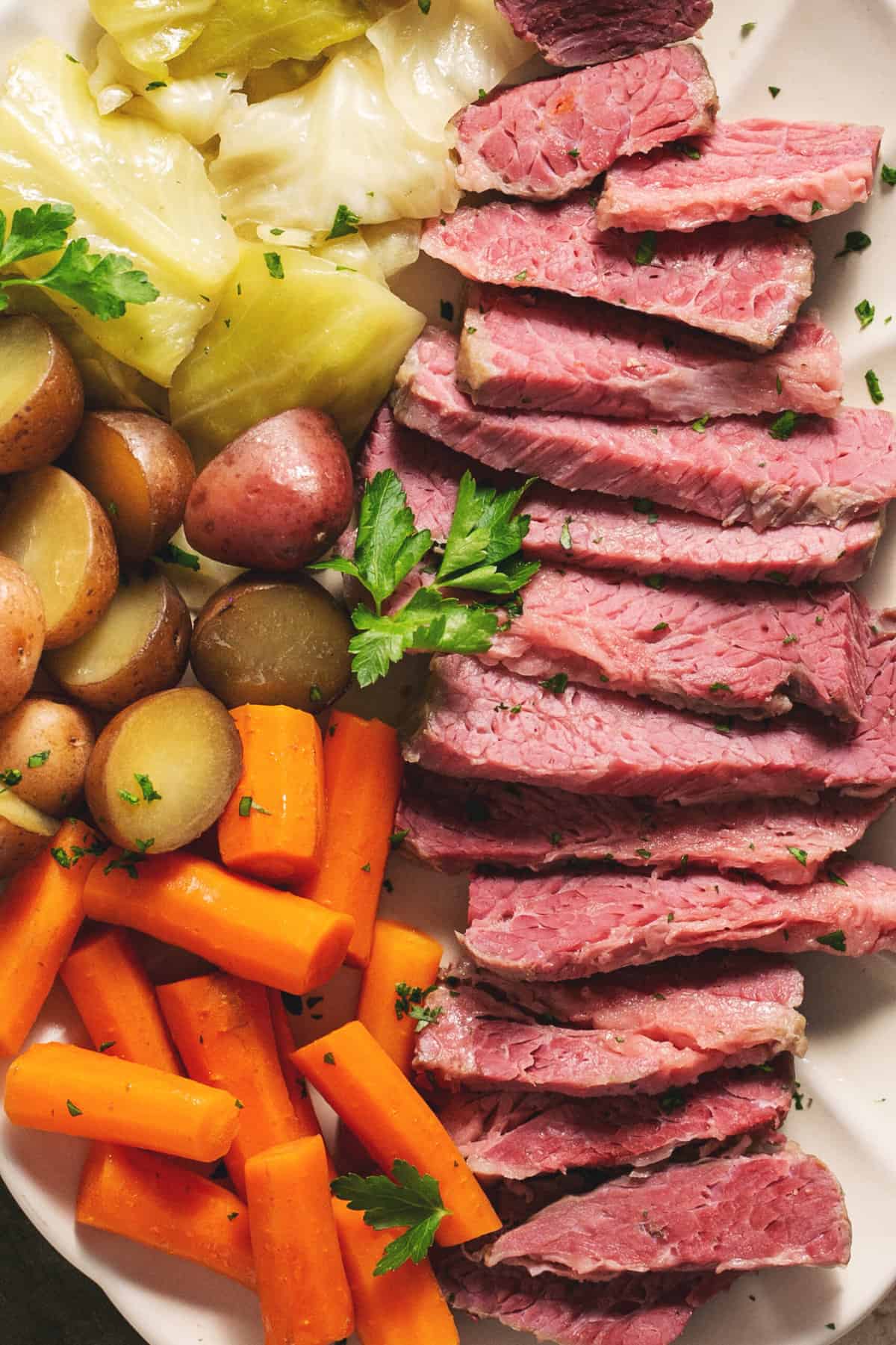 slow cooker corned beef with vegetables on a platter
