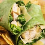 chicken and parmesan in tortilla with chips on plate
