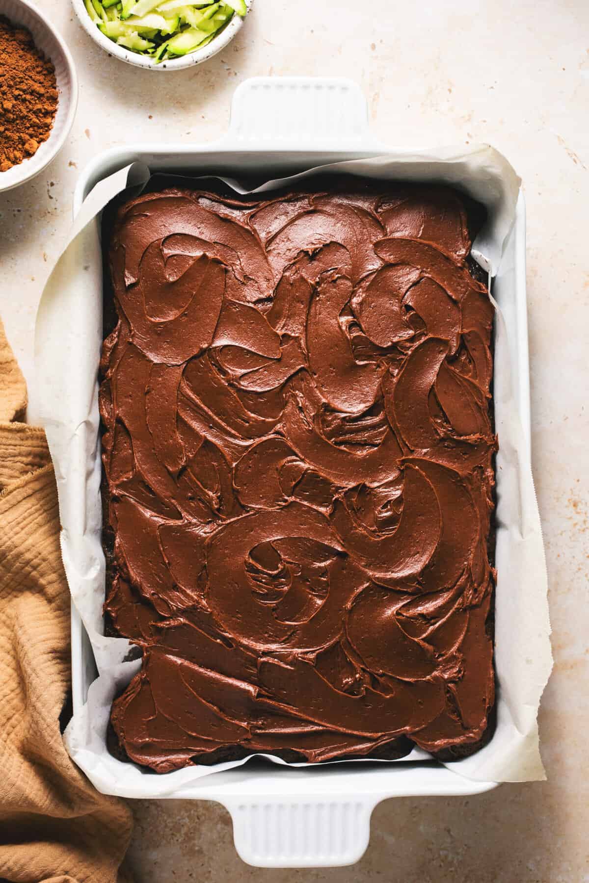 chocolate cake in pan with frosting swirls on top