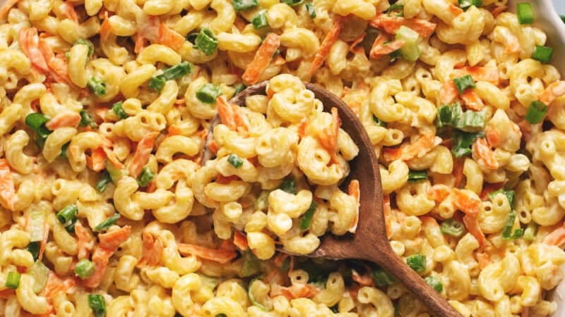 creamy hawaiian mac salad in bowl with wooden serving spoon