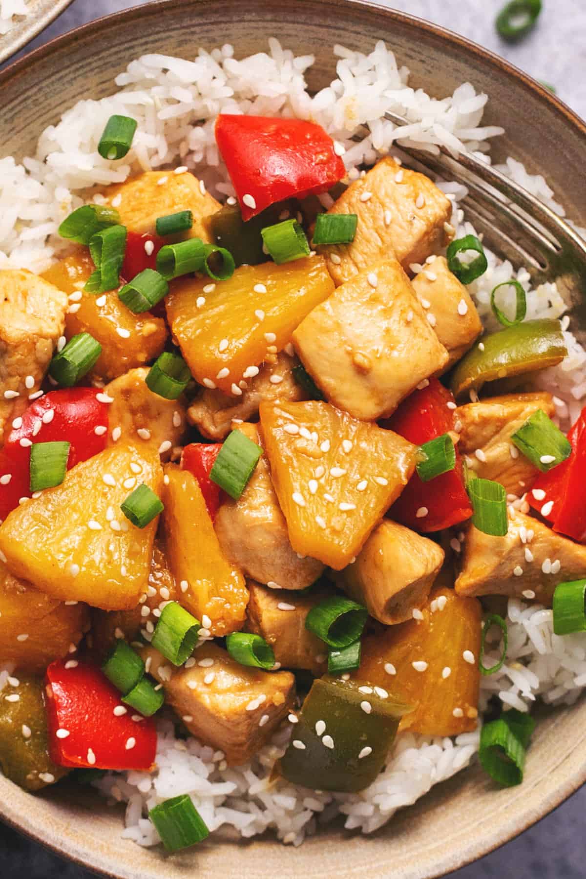 pineapple chicken with sesame seeds in bowl