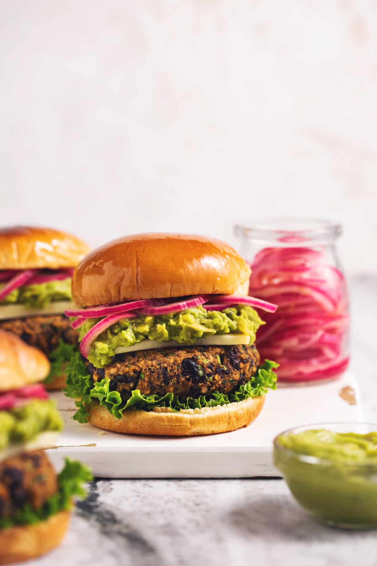 burger with avocado and pickled onions