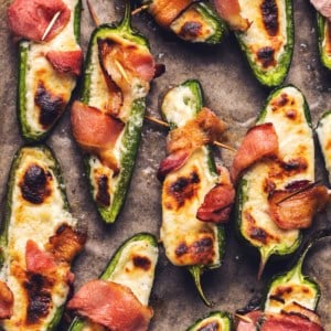 cooked jalapenos stuffed with cheese and wrapped with bacon