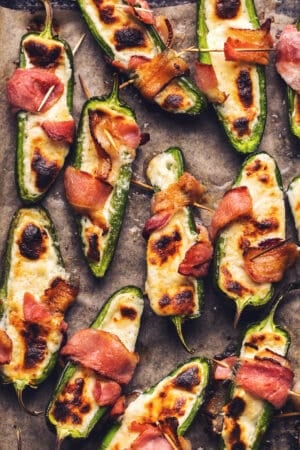 cooked jalapenos stuffed with cheese and wrapped with bacon