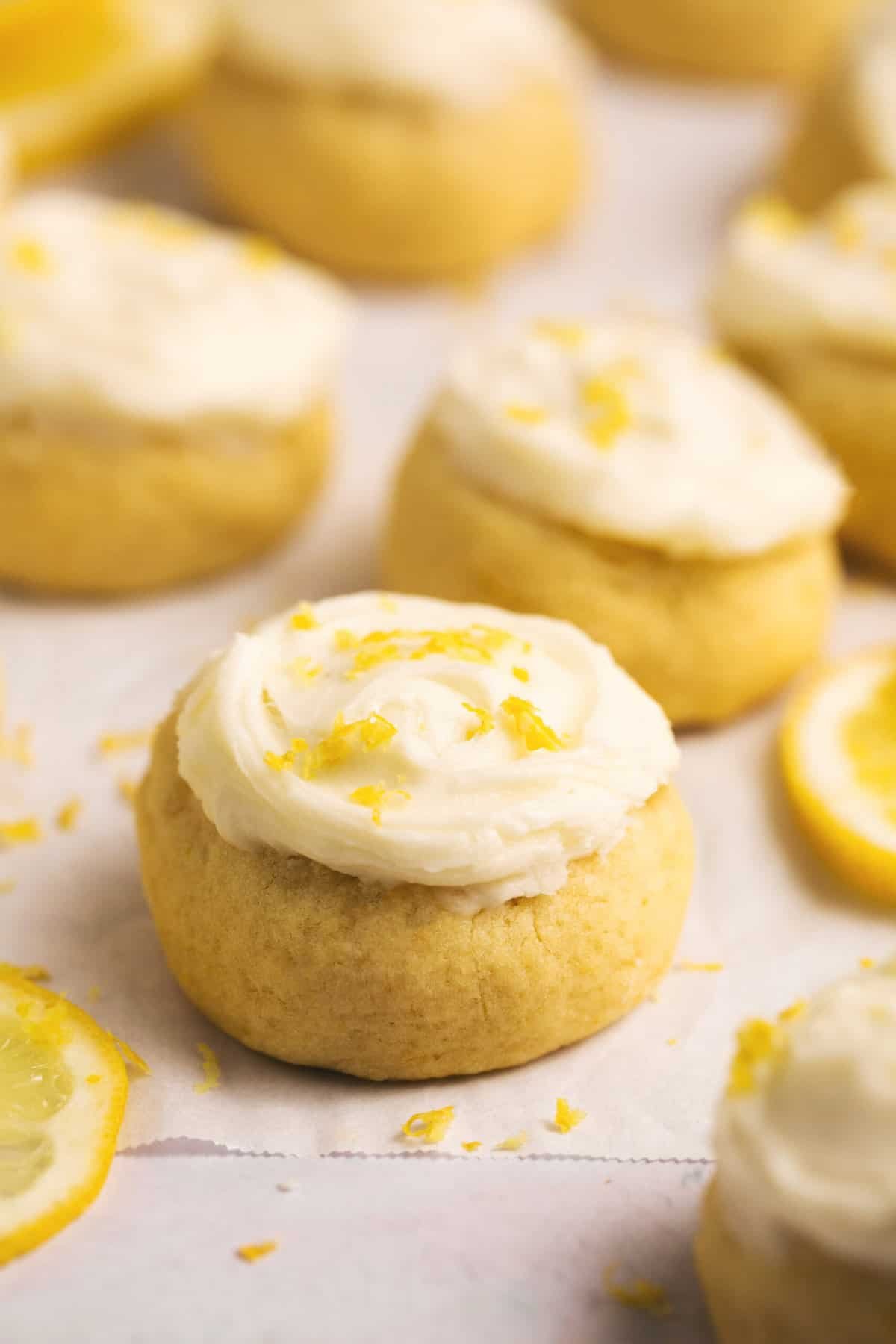 lemon cookies with icing and lemon zest garnish