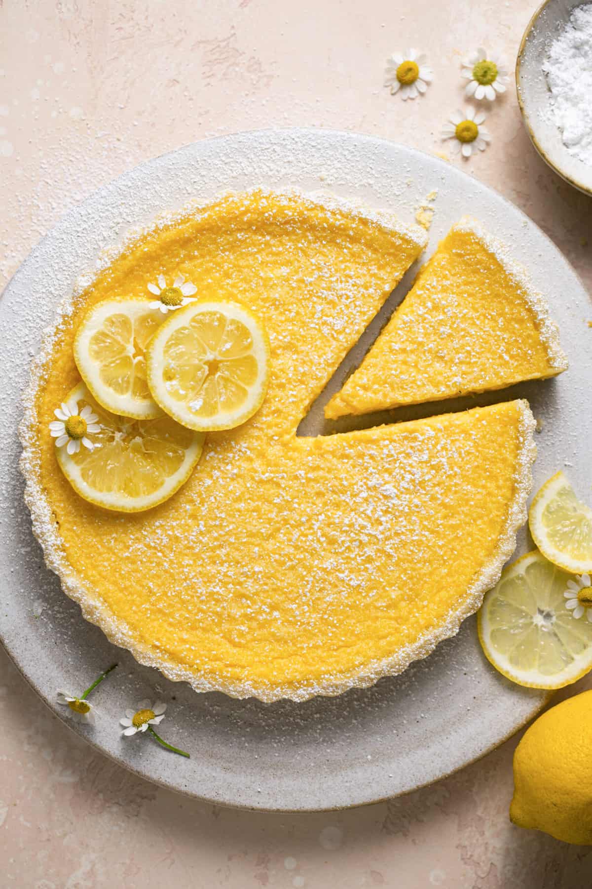 overhead view of lemon tart with single piece cut out