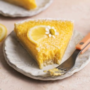 slice of lemon tart with bite missing on plate