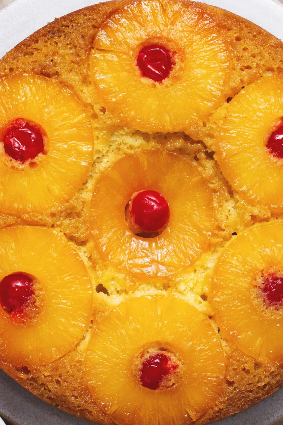 up close baked pineapple rings with cherries on top of cake
