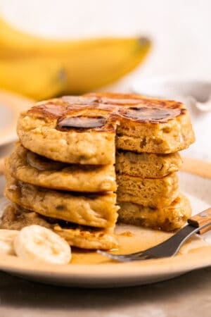 stack of banana pancakes with piece missing