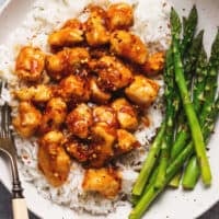 honey sriracha chicken over rice with roasted asparagus