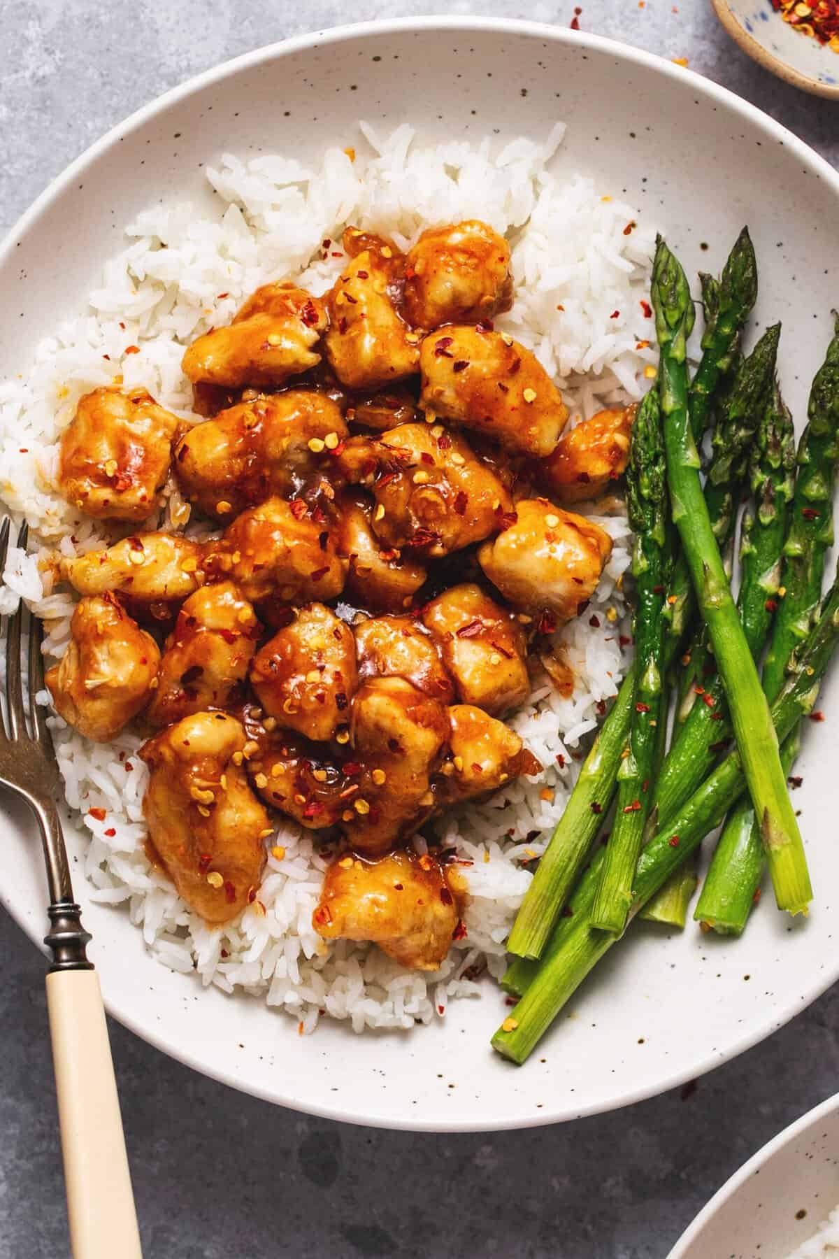 honey sriracha chicken over rice with roasted asparagus