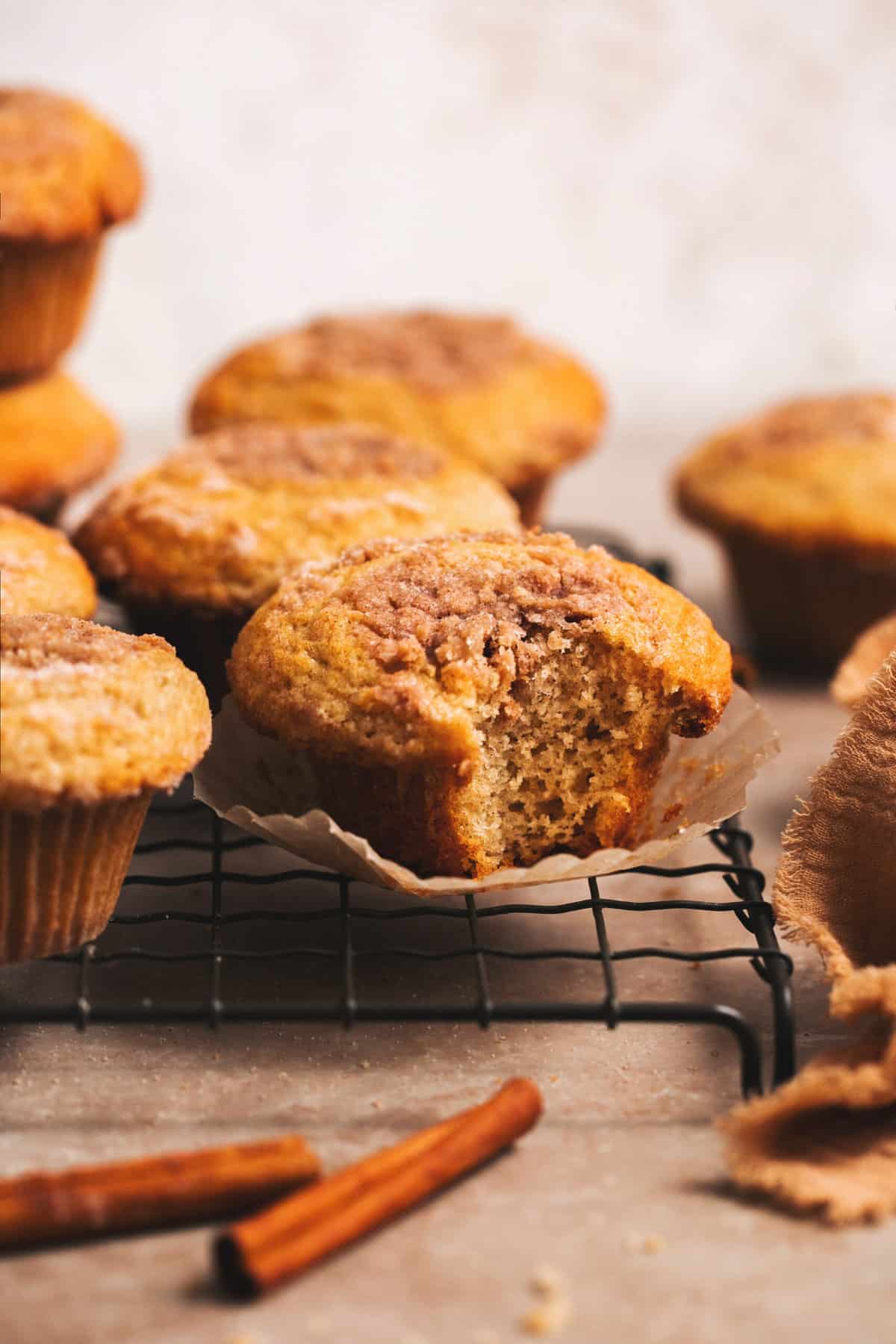 muffin with cinnamon topping and bite missing