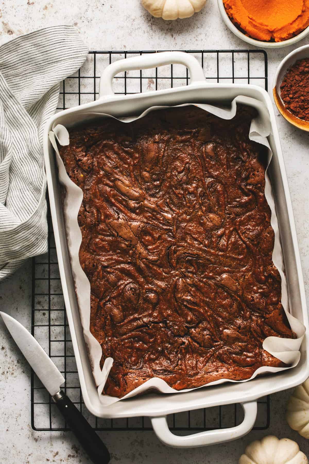 un-cut pumpkin brownies in pan on cooling rack