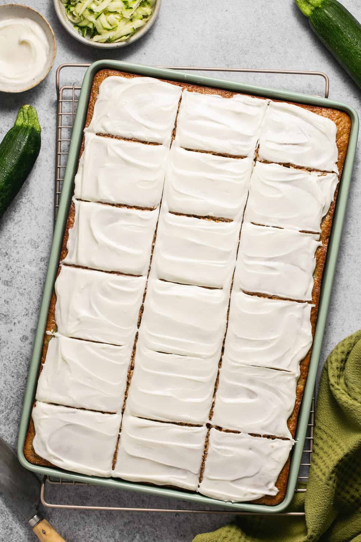 sliced sheet cake with cream cheese icing