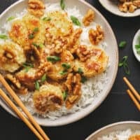 honey walnut chinese shrimp in bowl with rice and chopsticks