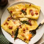 plate of butternut squash ravioli topped with bacon
