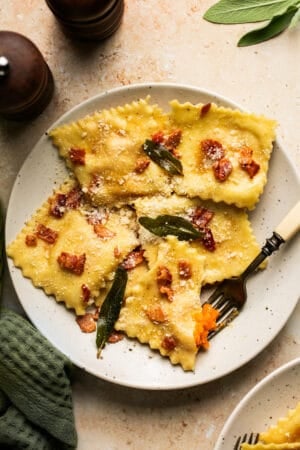 plate of butternut squash ravioli topped with bacon