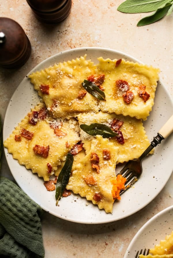 plate of butternut squash ravioli topped with bacon