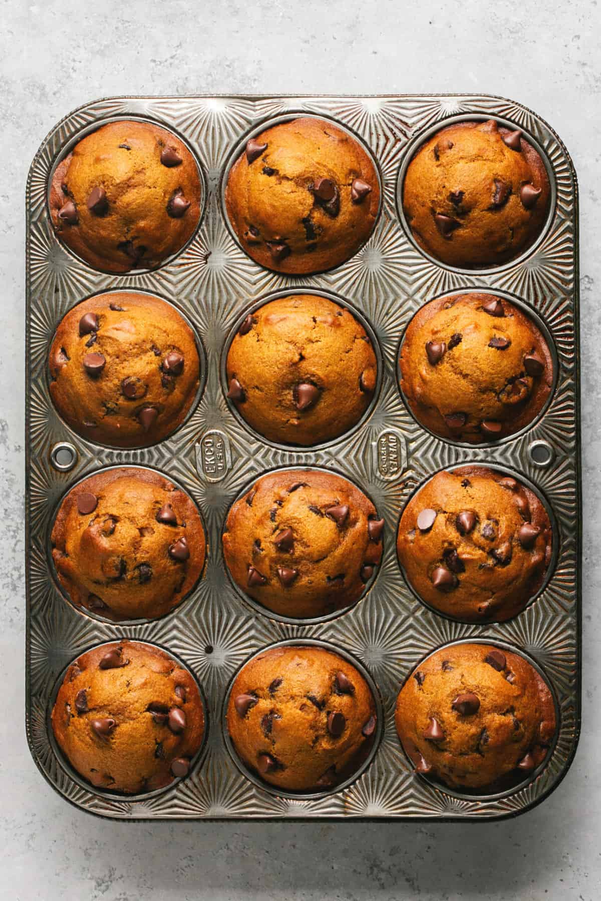 pumpkin muffins with chocolate chips in muffin tin