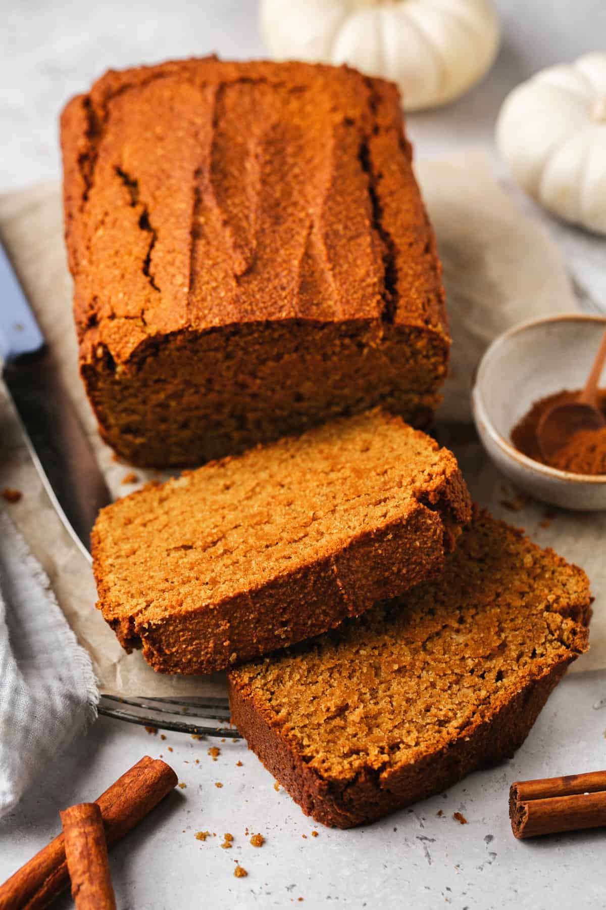 loaf of gluten free pumpkin bread with two slices cut