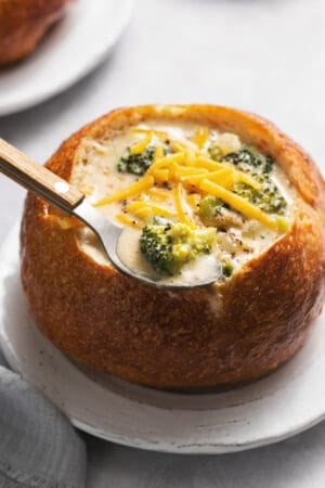 panera bread cheddar broccoli soup in bread bowl with spoon