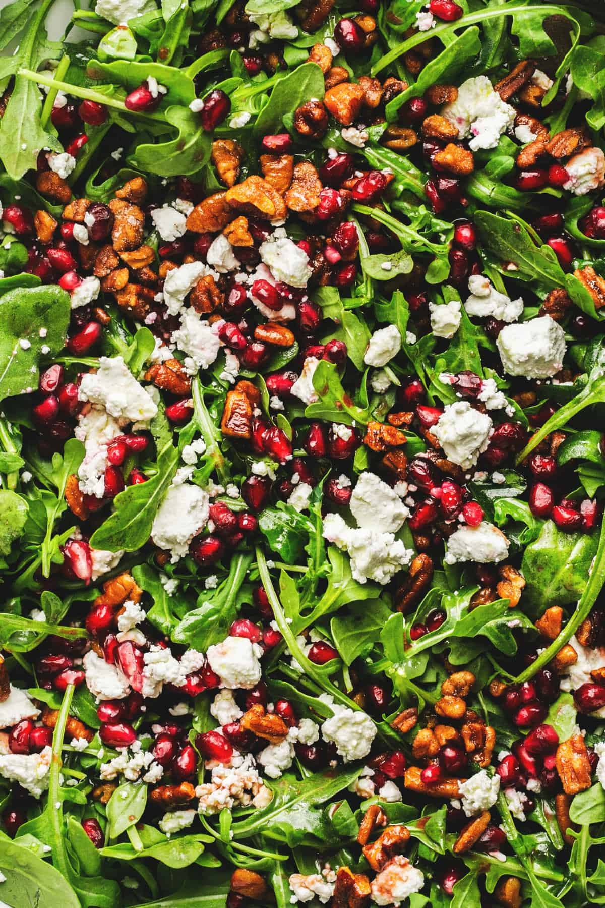 up close pomegranate, feta, and arugula salad