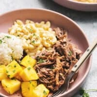 plate of kalua pork with macaroni salad, rice, and pineapple