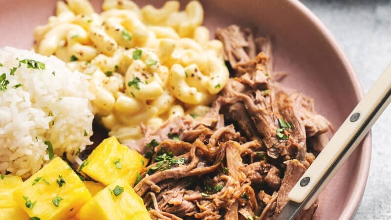 plate of kalua pork with macaroni salad, rice, and pineapple