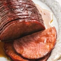 slow cooker glazed ham, sliced and resting on platter