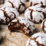 chocolate crinkle cookie with bite out on parchment paper