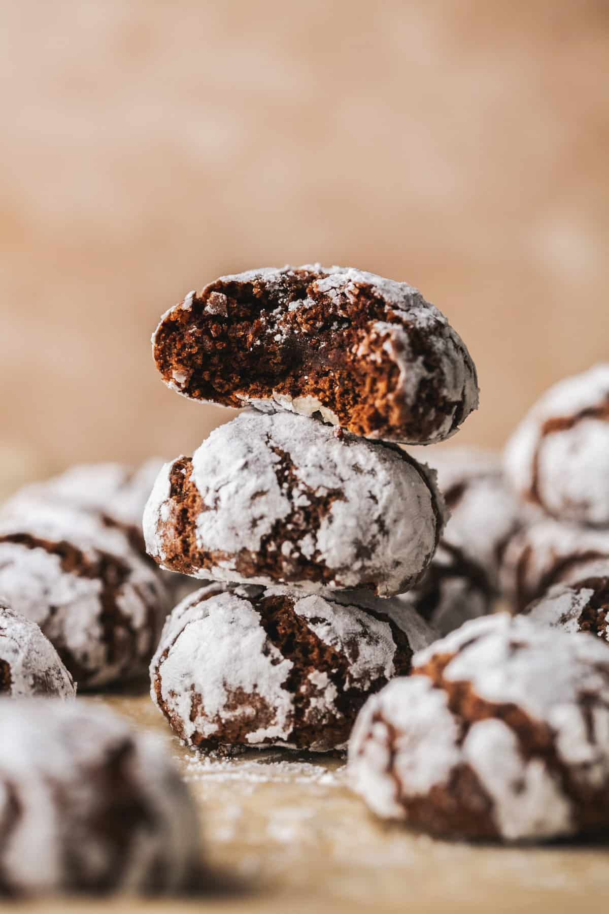 chocolate crinkle cookies stacked on top of each other