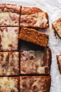 pieces of gingerbread cake with orange glaze on parchment paper